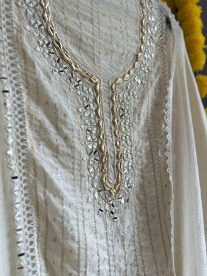 Luxurious Mul chanderi gold appliqué work suit